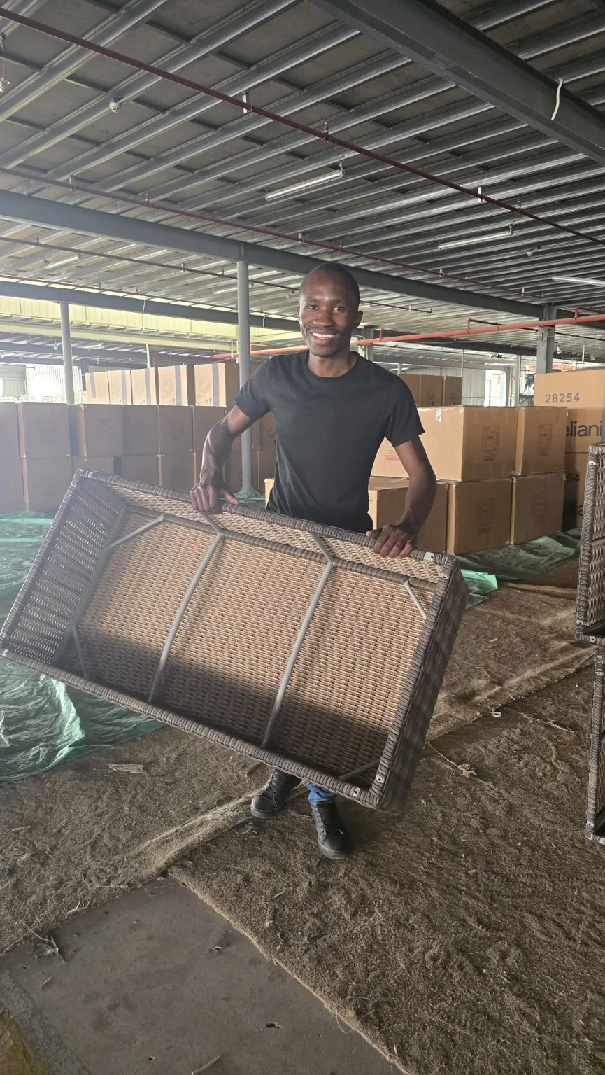 Victor reviewing woven outdoor furniture during a China supplier visit