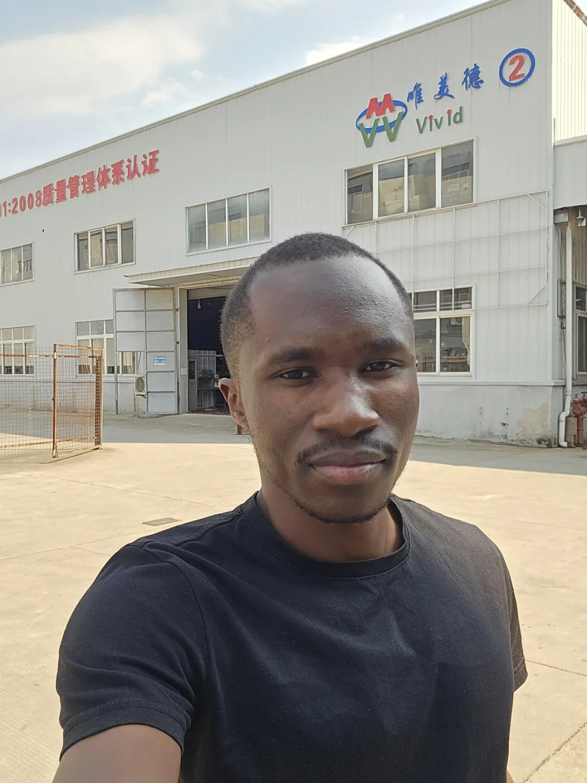 Victor Akoyo outside the Vivid supplier factory in China